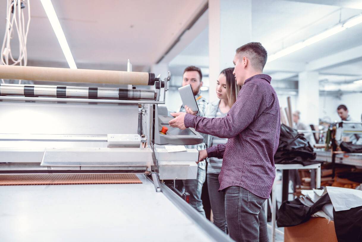 workers using textile printing equipment