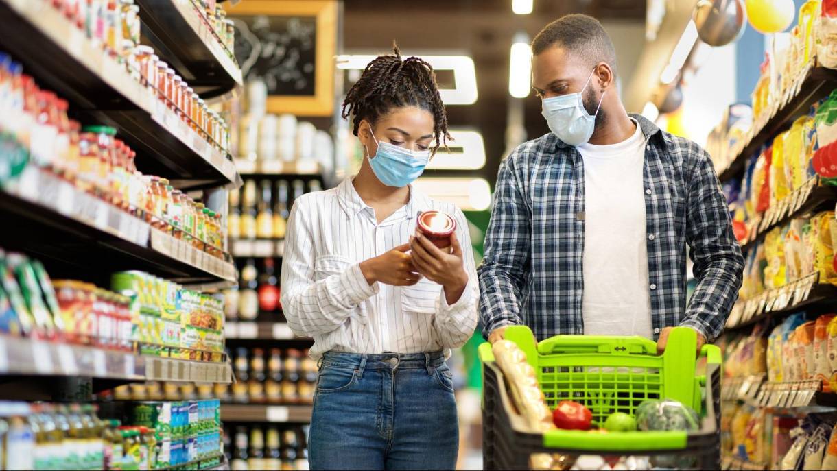 A young couple grocery shopping during Covid