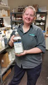 kao collins chemist ashley neyer holds a bottle of hand sanitizer