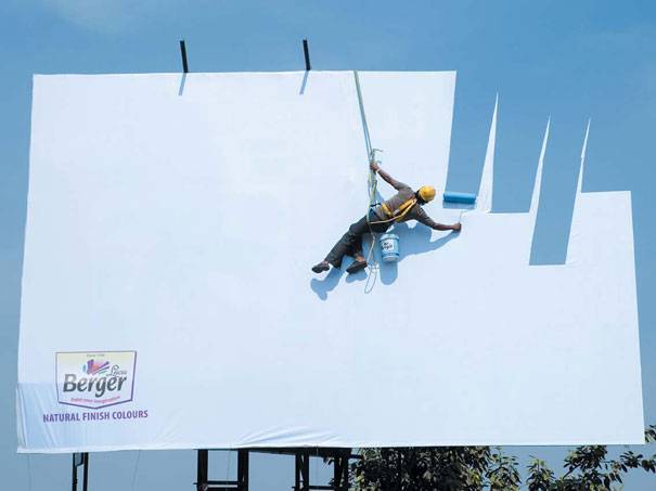 Painter painting a billboard