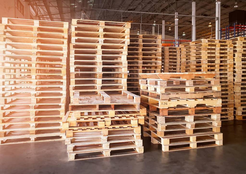 Heap of Wooden Pallets in Storage Warehouse.