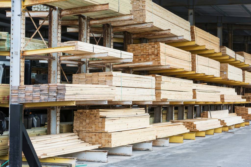Warehouse at a lumberyard with stacks of construction material on shelves