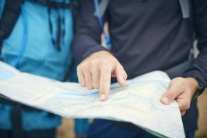 looking at a map printed on waterproof paper out in the field