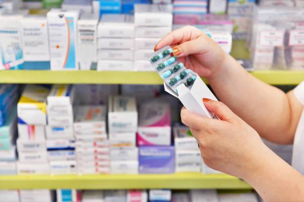 Hands holding packaged medicine capsules