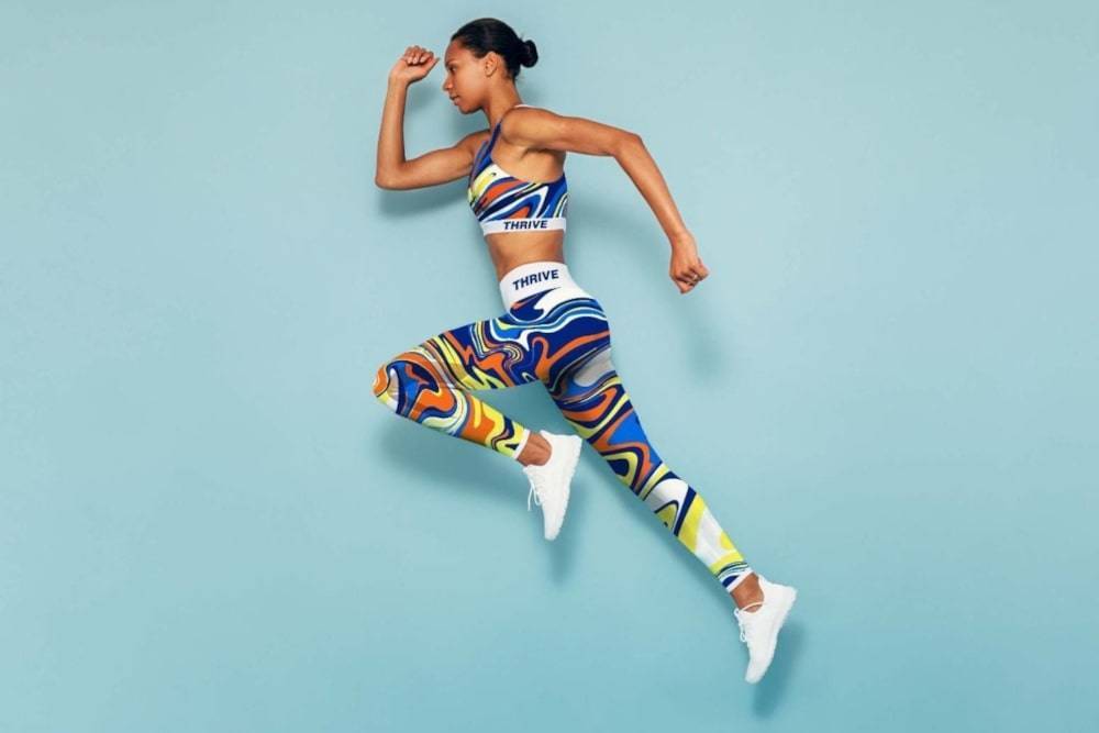 Woman running in colorful running suit