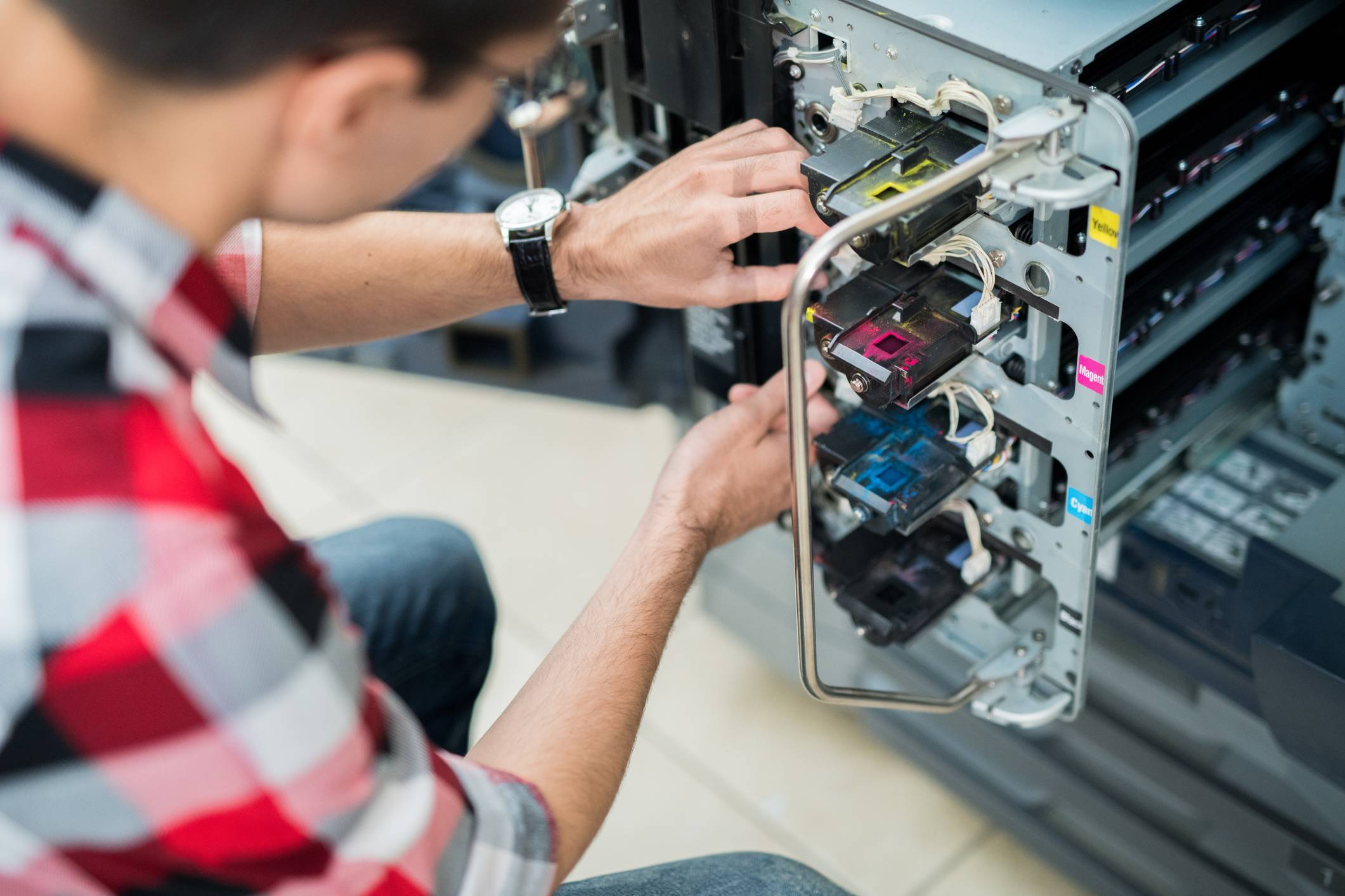 man repairing and working with inks and industrial inkjet printing equipment